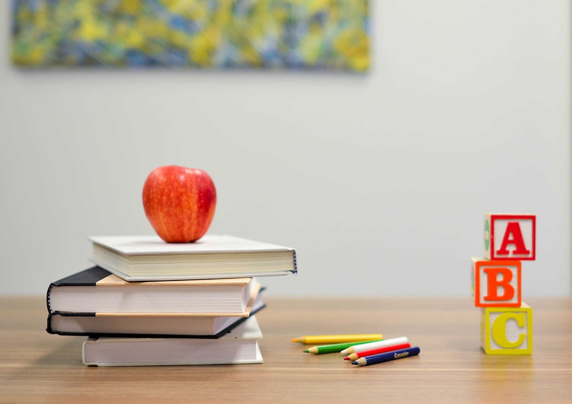 abcs of applied behavior analysis_KNR Therapy blog featured image_apple on top of books on desk
